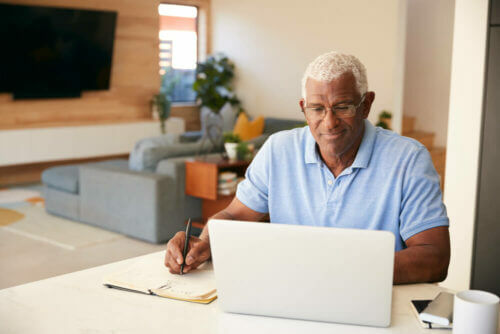 Older man paying bills online