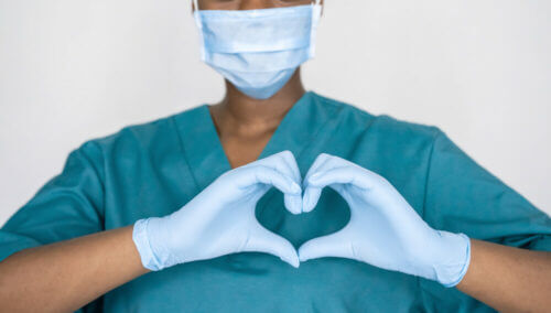 technician making a heart with their gloved hands