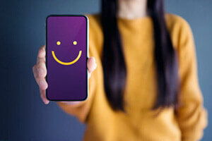 Close up of phone with happy face